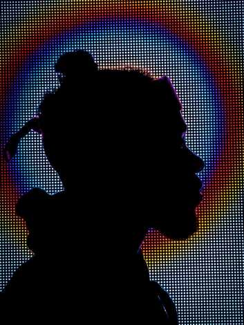Human with a screen displaying colourful lighting in the background